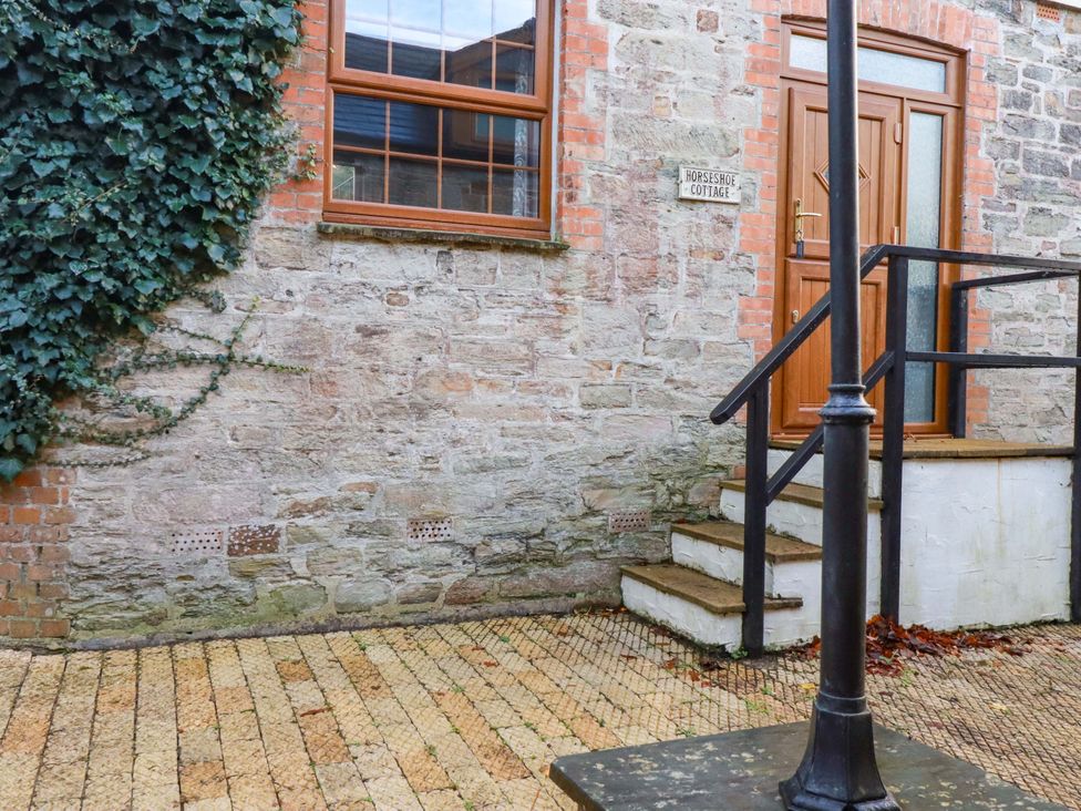 An entrance with a door and steps at Horseshoe Cottage in Falmouth