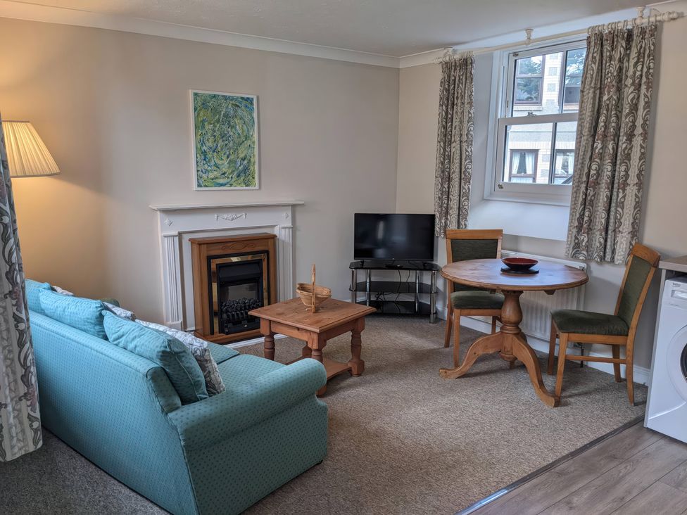 A living room with a sofa and coffee table at Horseshoe Cottage Budock Water near Falmouth