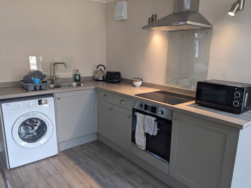 A kitchen with appliances and fixtures at Horseshoe Cottage Budock Water near Falmouth