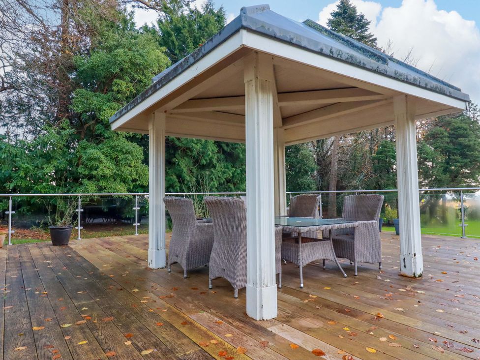An outdoor area with a gazebo and seating at The Hayloft in Falmouth