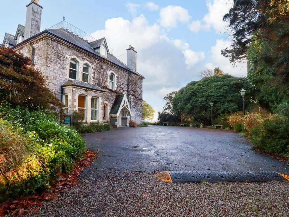 A building with windows and a driveway at The Hayloft in Falmouth