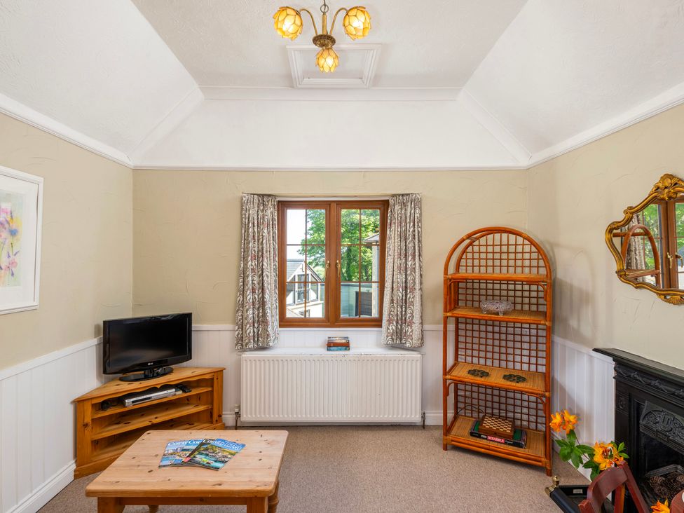 A living room with a television and coffee table at The Hayloft Budock Water near Falmouth