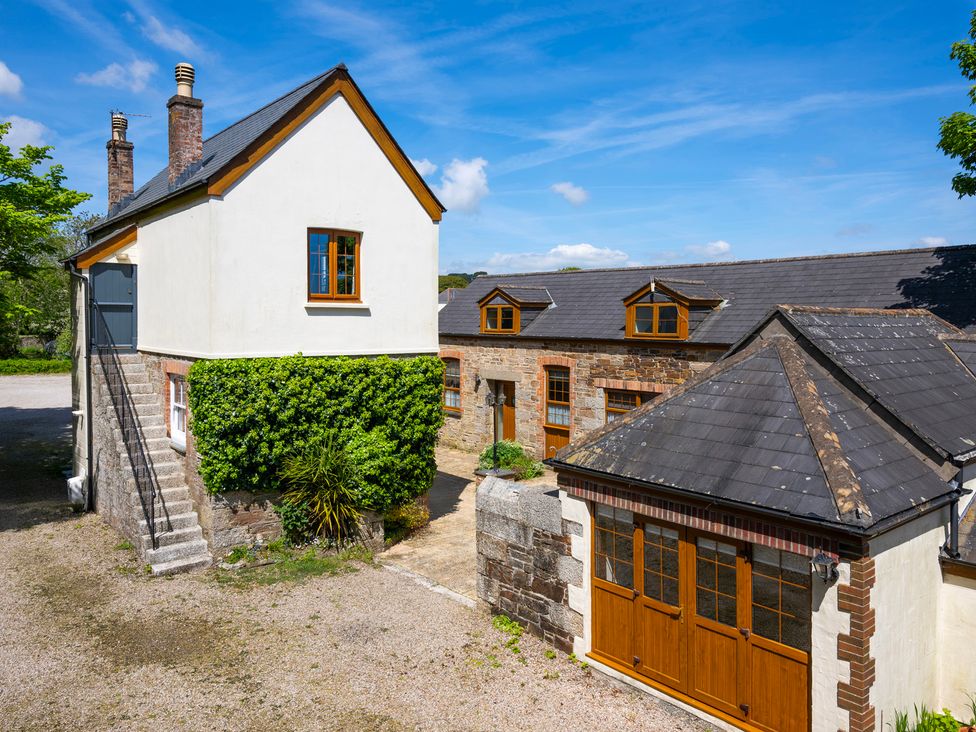 An exterior view of a building with a garage and steps at The Hayloft Budock Water near Falmouth