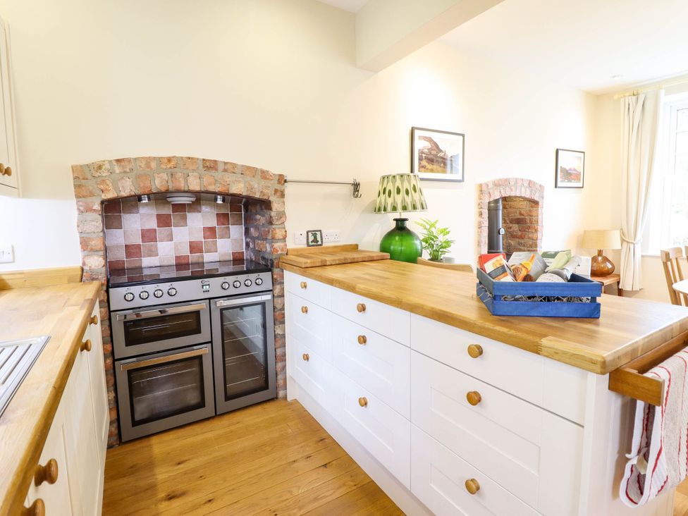 A kitchen with an oven and wooden countertops at Dolhiryd, Glyn Ceiriog, near Chirk