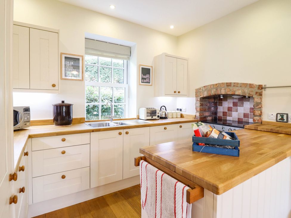 A kitchen with a sink and appliances at Dolhiryd in Glyn Ceiriog, near Chirk
