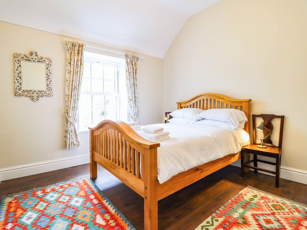A bedroom with a bed and bedside table at Dolhiryd in Glyn Ceiriog, near Chirk