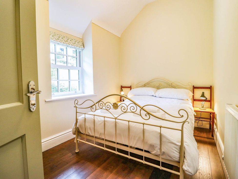 A bedroom with a bed and nightstand at Dolhiryd in Glyn Ceiriog, near Chirk