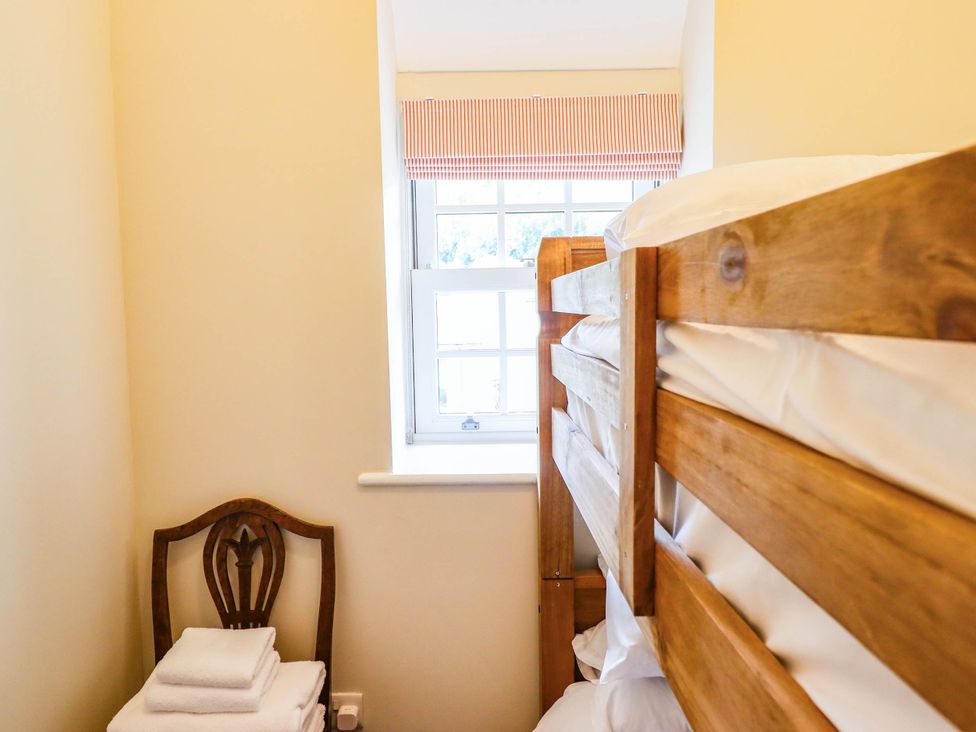 A bedroom with a bunk bed and towels at Dolhiryd in Glyn Ceiriog, near Chirk