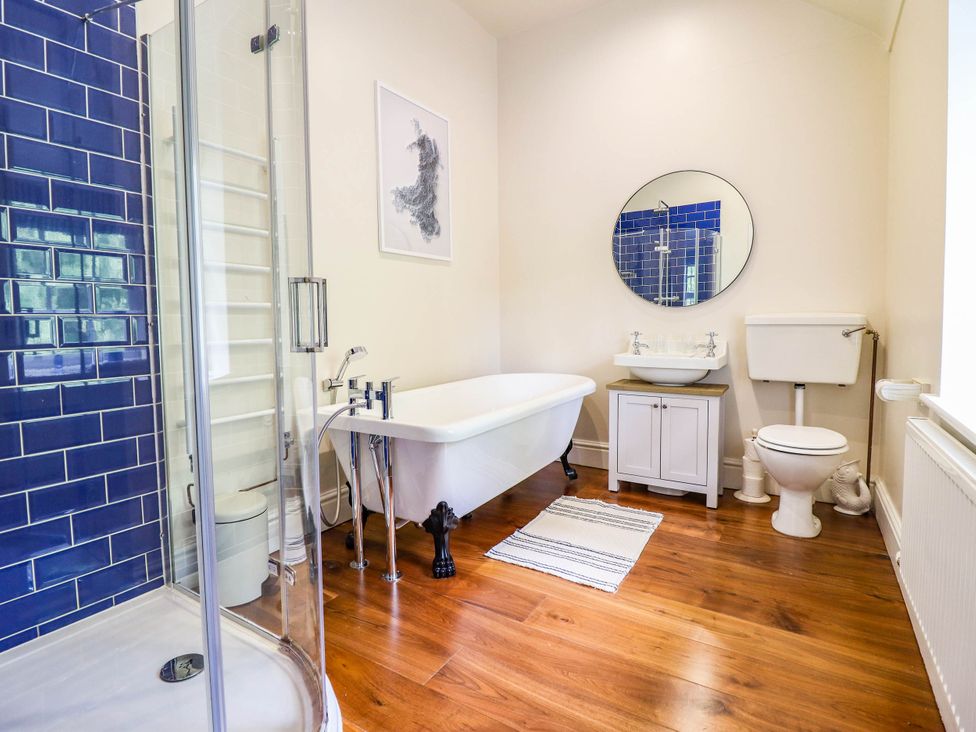 A bathroom featuring a bathtub, shower, and toilet at Dolhiryd in Glyn Ceiriog, near Chirk