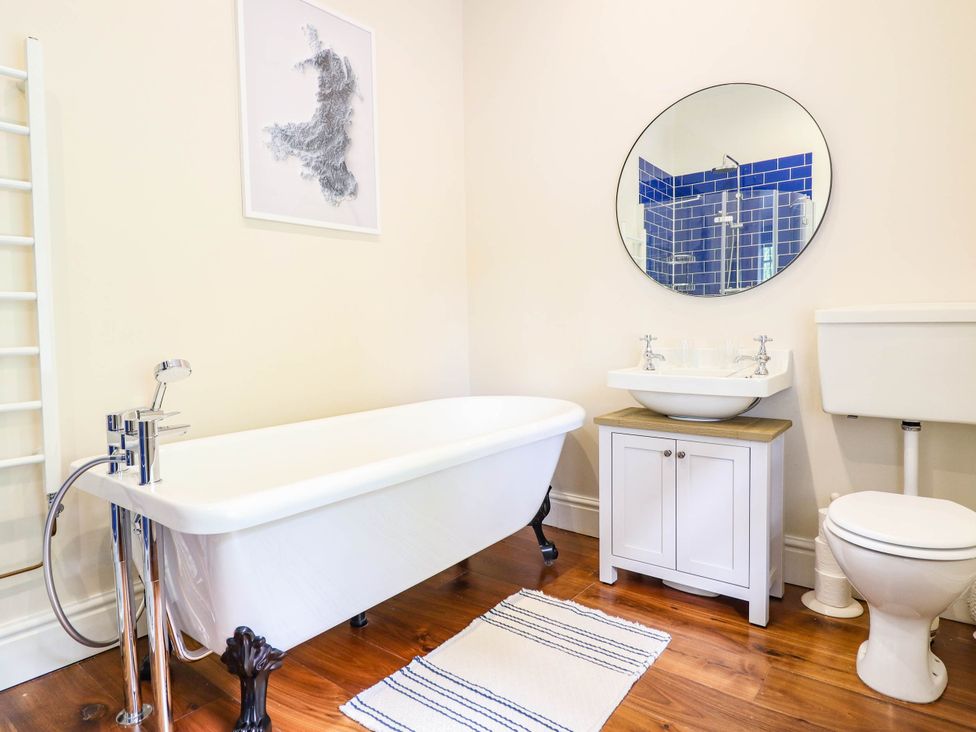 A bathroom with a bathtub and sink at Dolhiryd Glyn Ceiriog near Chirk