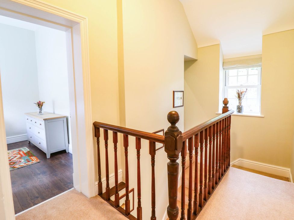 A hallway with staircase and dresser at Dolhiryd in Glyn Ceiriog, near Chirk
