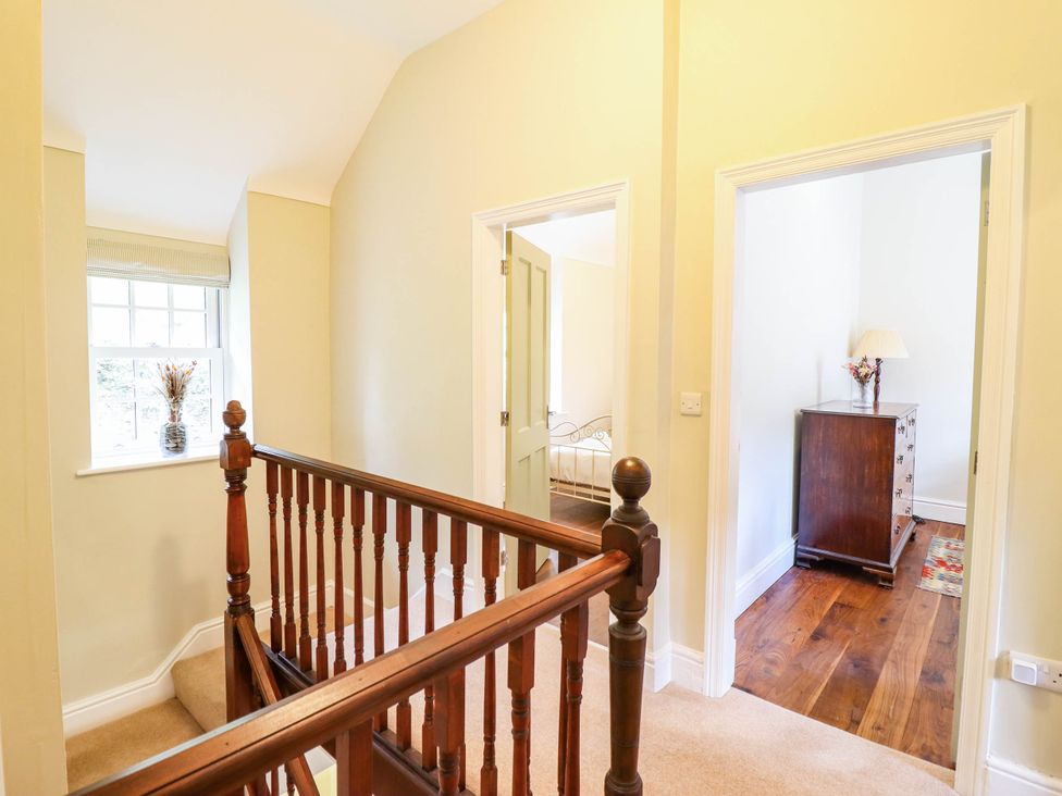 A hallway with a staircase and a window at Dolhiryd in Glyn Ceiriog, near Chirk