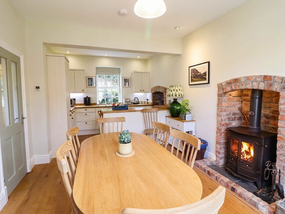 A kitchen with a dining table and chairs at Dolhiryd, Glyn Ceiriog, near Chirk