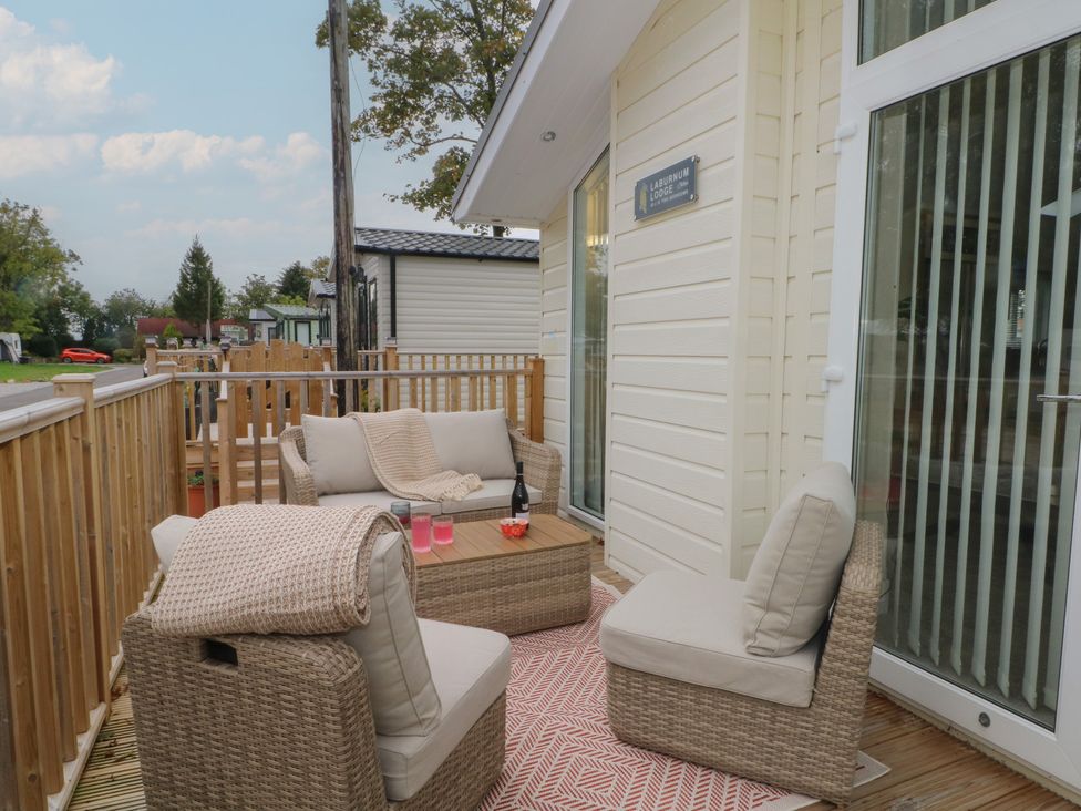 An outdoor seating area with a sofa and coffee table at Labernum in Lytham St. Annes