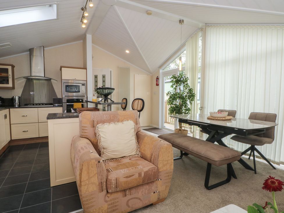 A dining area with a kitchen and seating at Labernum Lytham St. Annes
