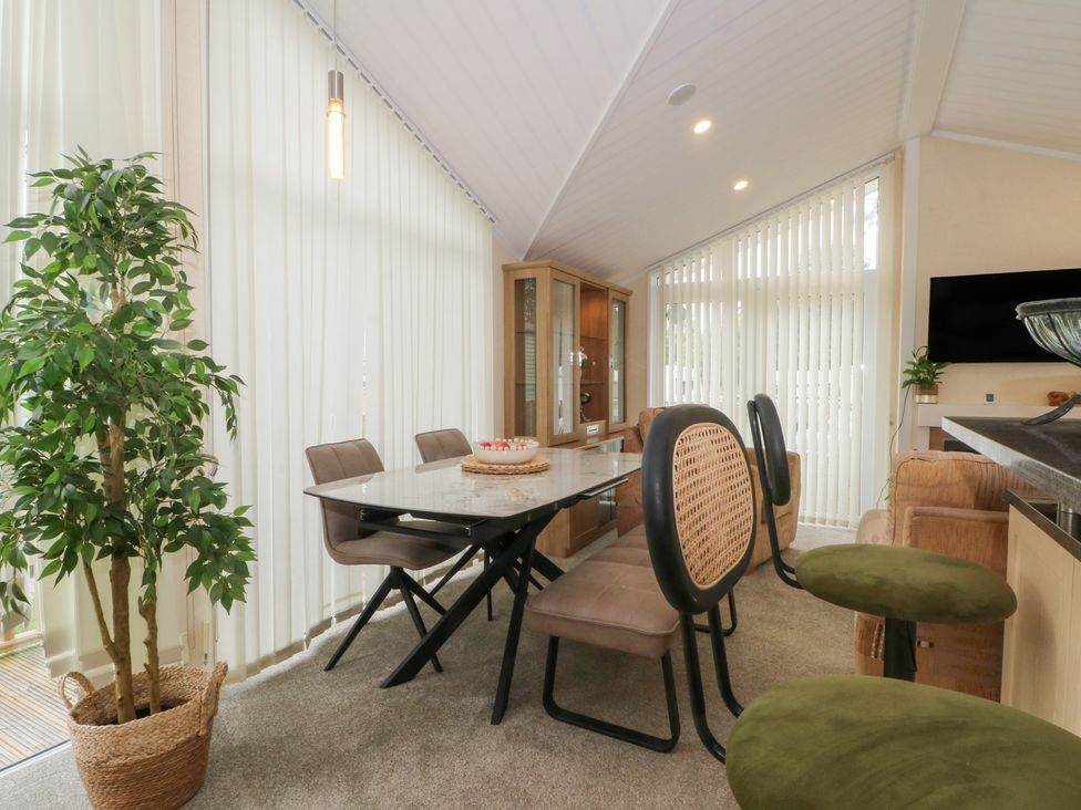 A dining room with a table and chairs at Labernum in Lytham St. Annes