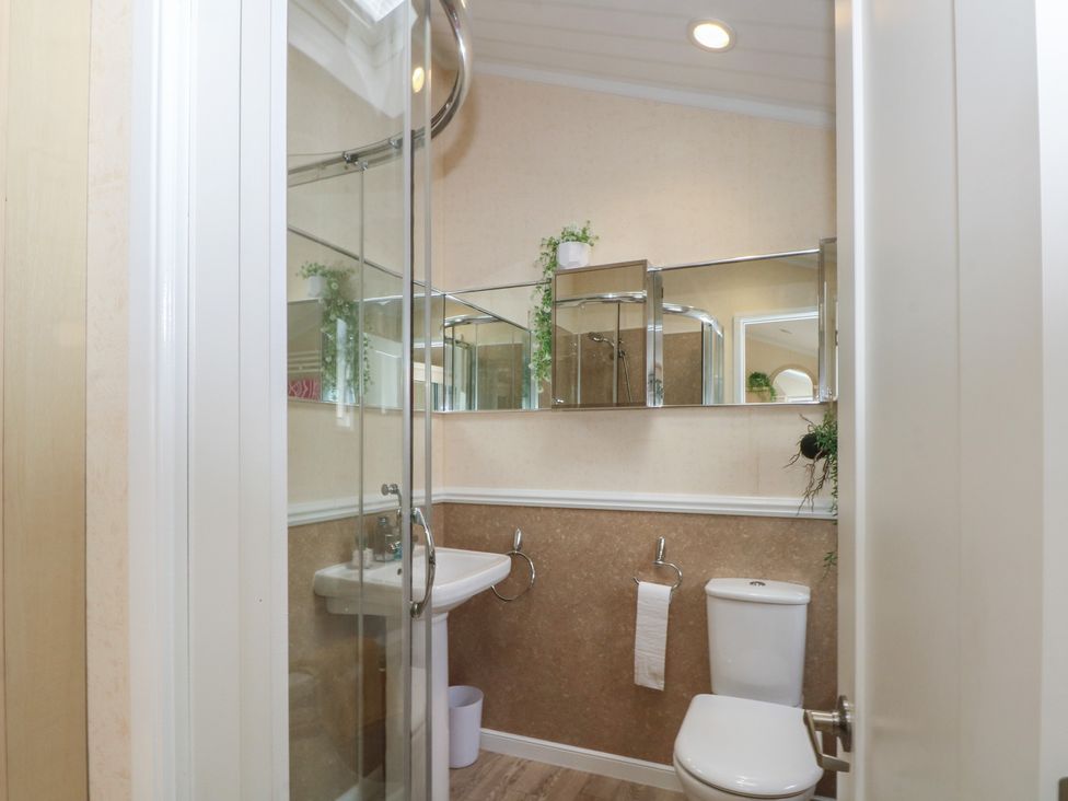 A bathroom with shower, sink, and toilet at Labernum in Lytham St. Annes