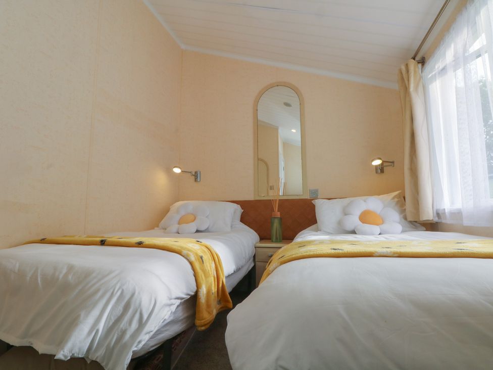 A bedroom with two beds and a mirror at Labernum in Lytham St. Annes
