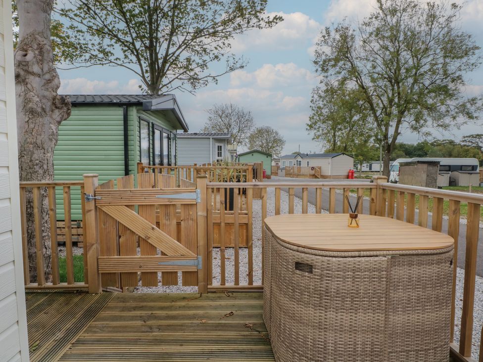 An outdoor area with a hot tub and fence at Labernum in Lytham St. Annes