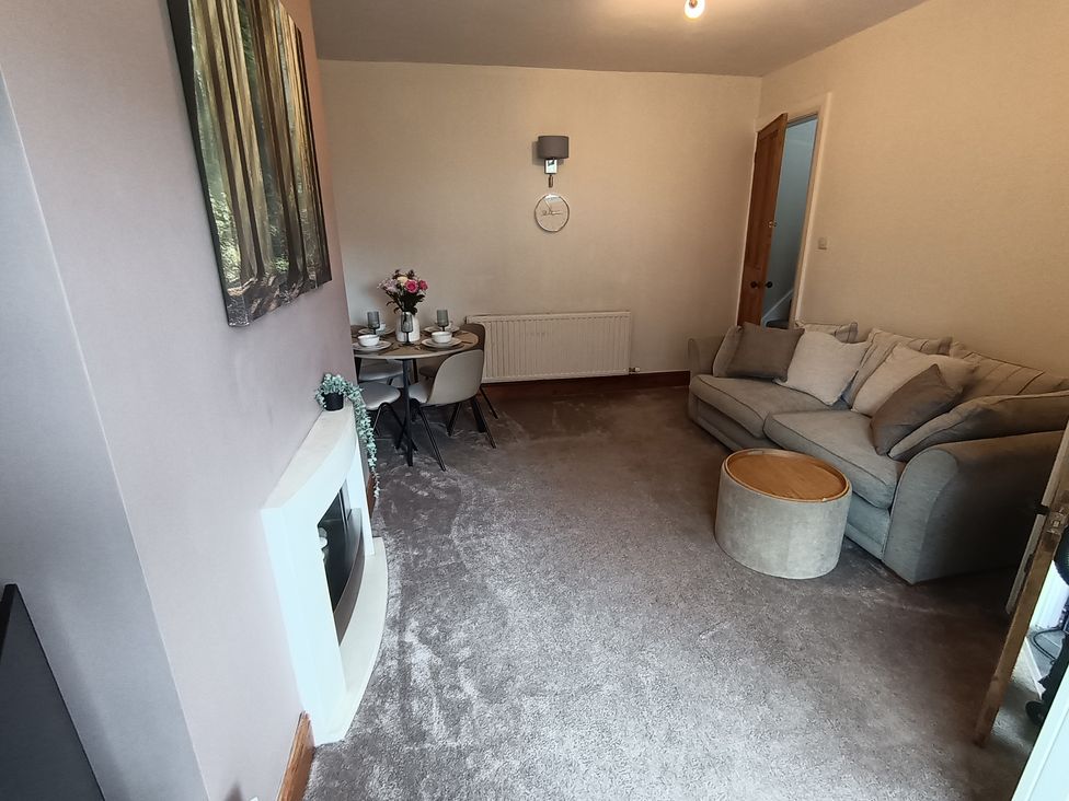 A living room with a sofa and dining table at 14 Lindon Street
