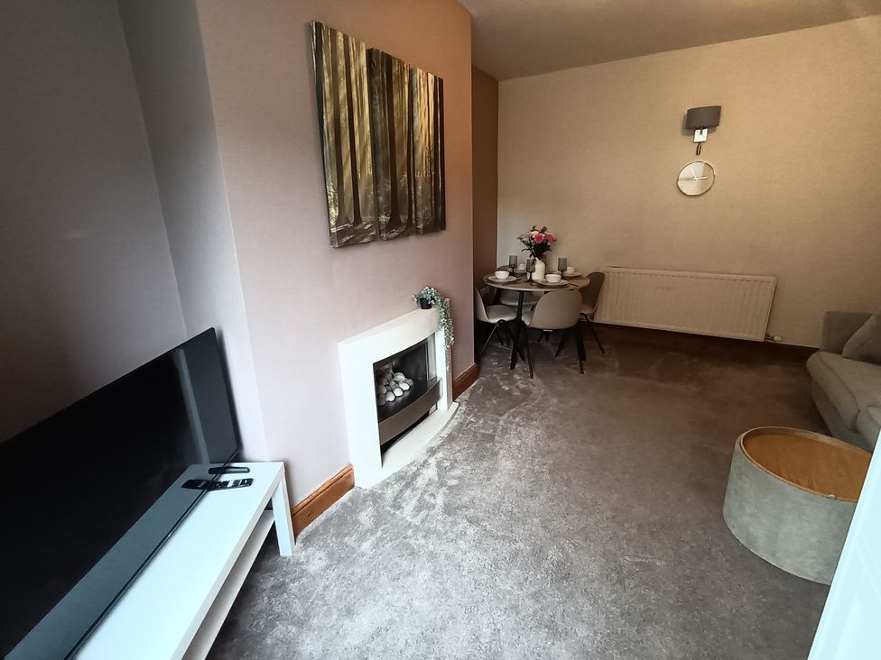 A living room with a dining table and sofa at 14 Lindon Street