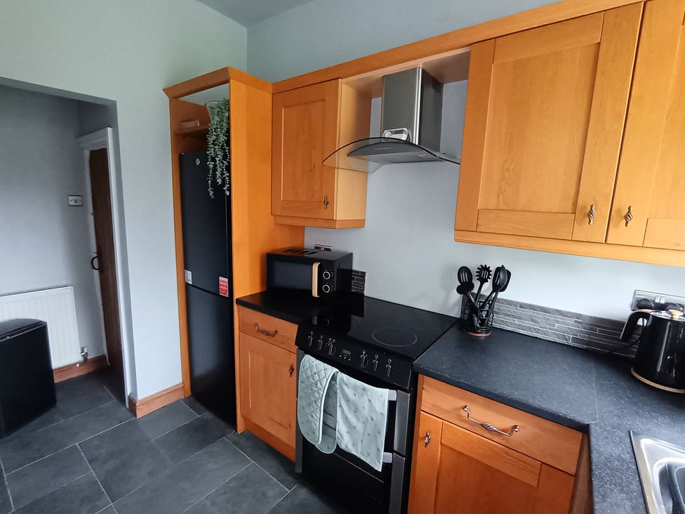 A kitchen with cabinets, oven, sink, microwave, and refrigerator at 14 Lindon Street