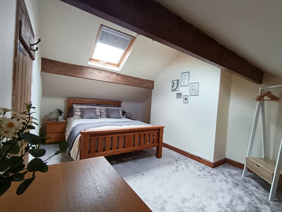 A bedroom with a bed and bedside table at 14 Lindon Street