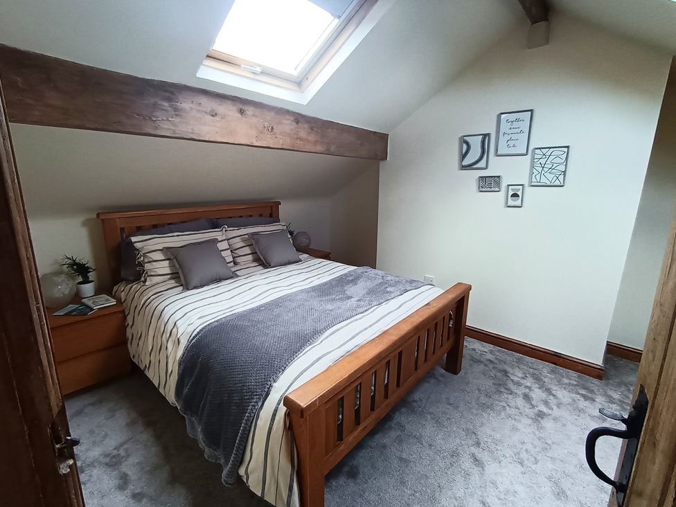 A bedroom with a bed and wall art at 14 Lindon Street