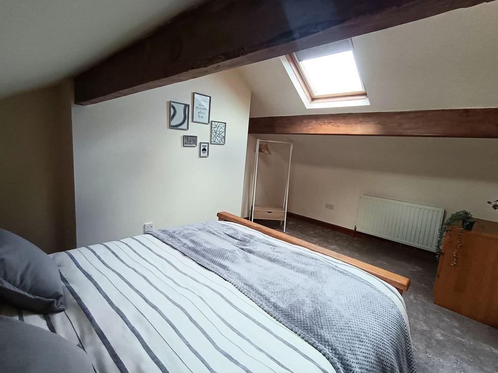 A bedroom with a bed and pictures on the wall at 14 Lindon Street