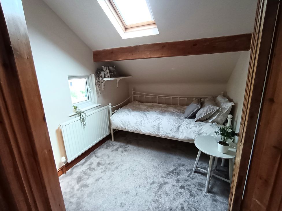 A bedroom with a bed and a table at 14 Lindon Street