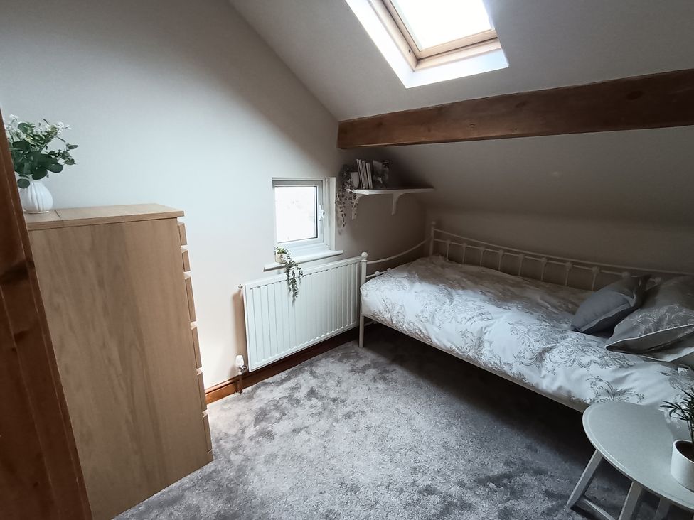 A bedroom with a bed and dresser at 14 Lindon Street 
