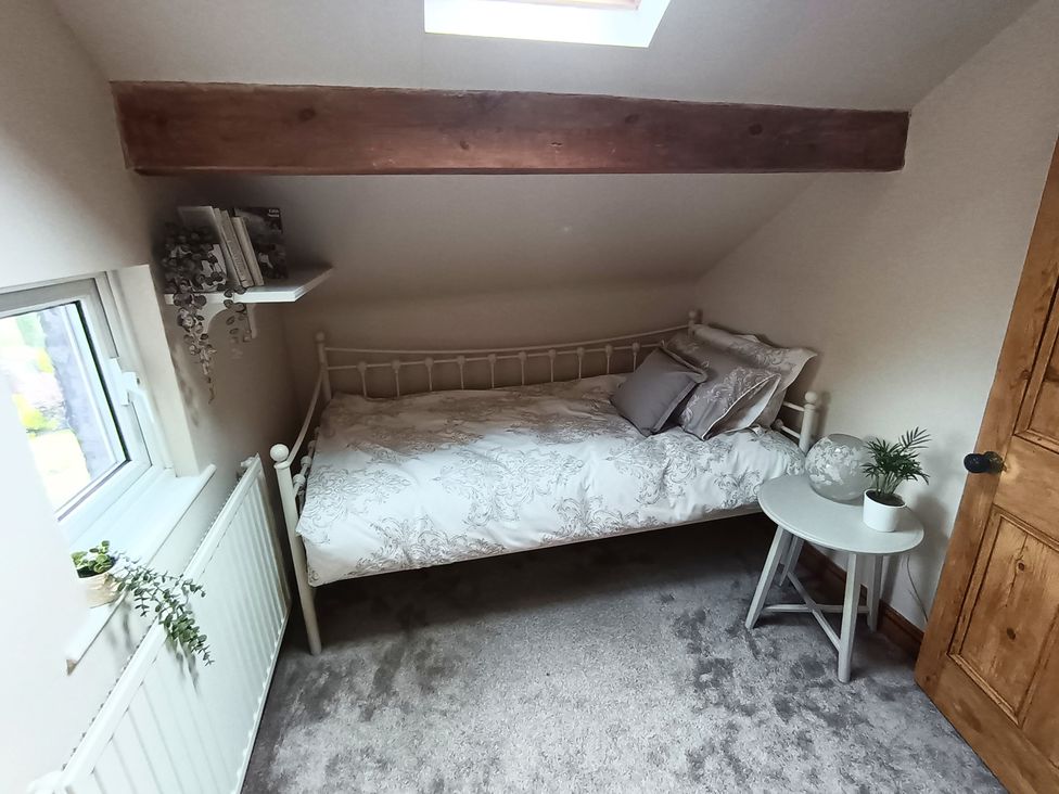 A bedroom with a bed and shelf at 14 Lindon Street