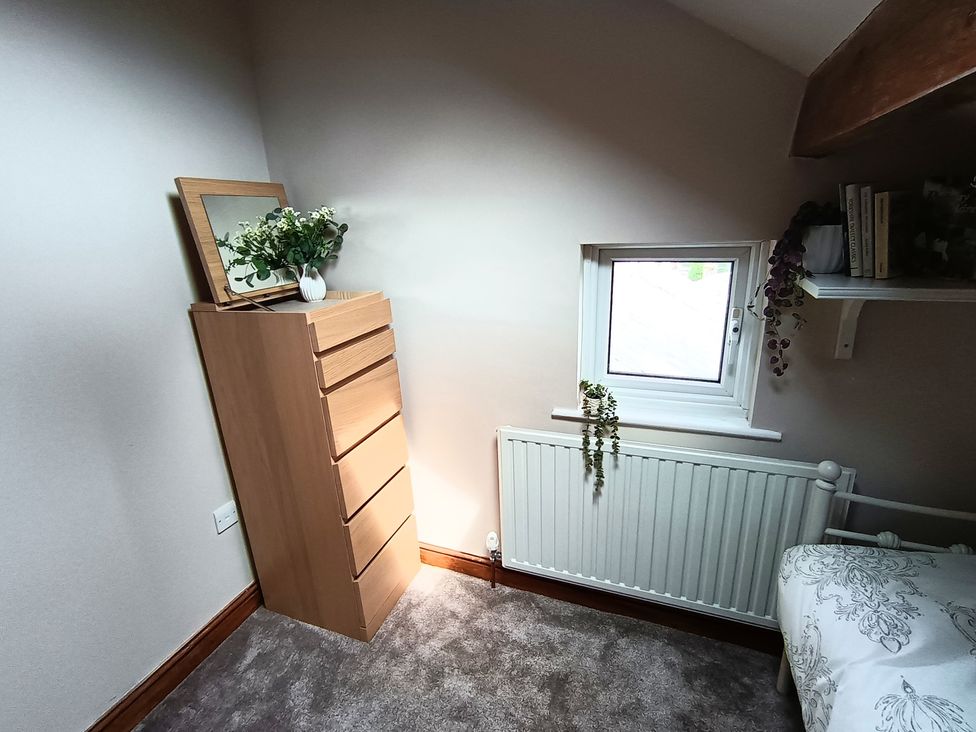 A bedroom with a dresser and a window at 14 Lindon Street