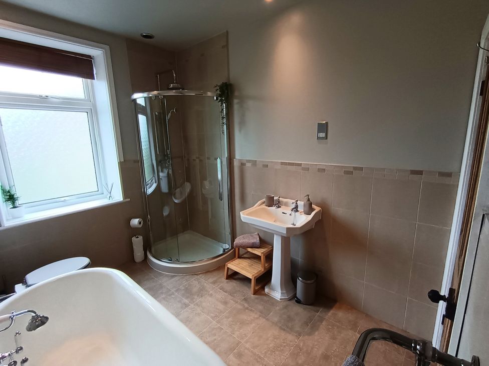 A bathroom with a shower, bathtub, sink and toilet at 14 Lindon Street