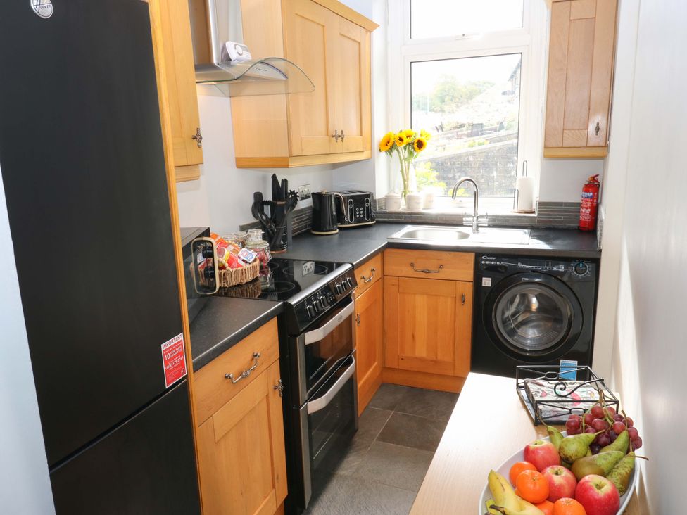 A kitchen with appliances and a fruit bowl at Steam View Cottage in Haworth
