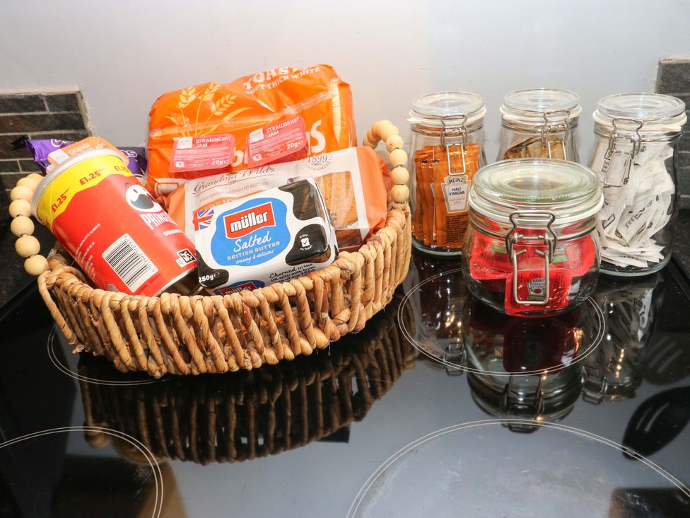 A collection of food items on a kitchen countertop at Steam View Cottage in Haworth