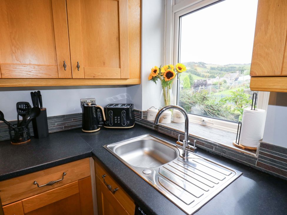 A kitchen with a sink and utensils at Steam View Cottage in Haworth