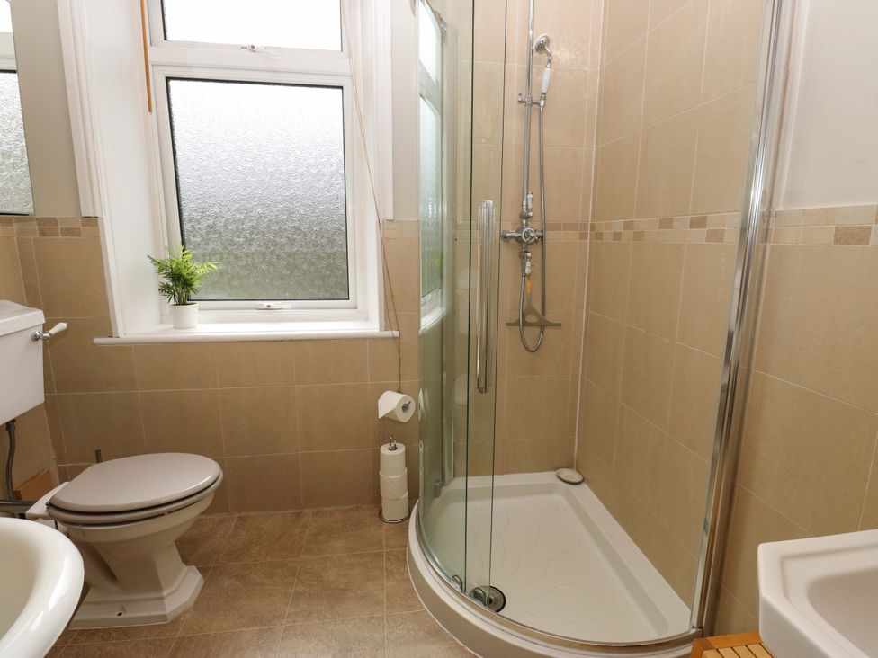 A bathroom with a shower and toilet at Steam View Cottage in Haworth