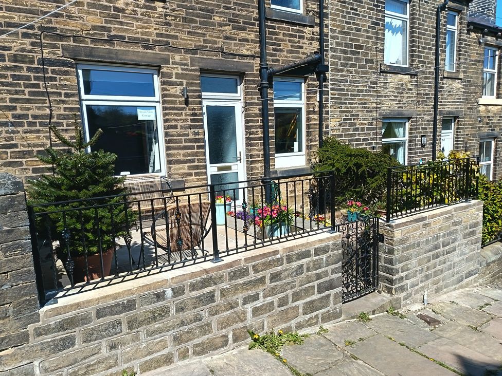 An outdoor area with plants and seating at Steam View Cottage in Haworth