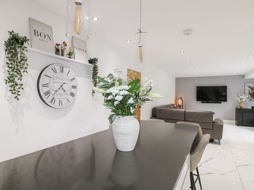 A living room with a floral arrangement on a table at Rockcliffe Grange in Mansfield