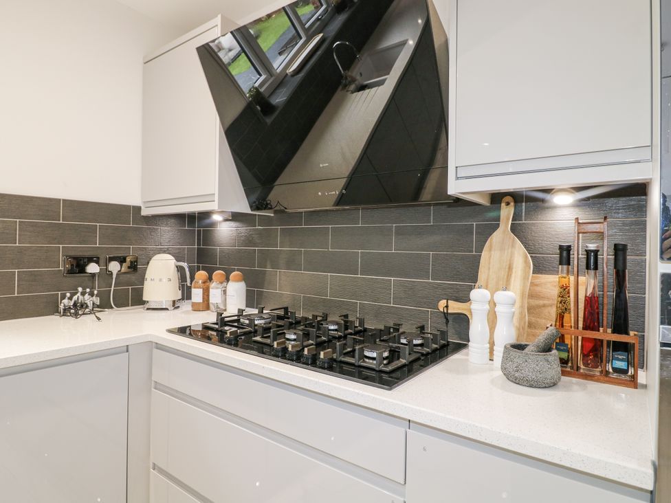 A kitchen with a gas stove and various kitchen utensils at Rockcliffe Grange in Mansfield