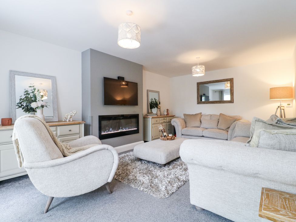 A living room with a sofa and armchair at Rockcliffe Grange in Mansfield