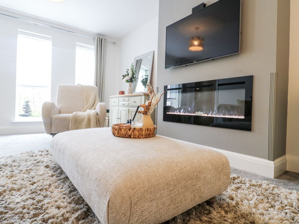 A living room with a sofa and fireplace at Rockcliffe Grange in Mansfield
