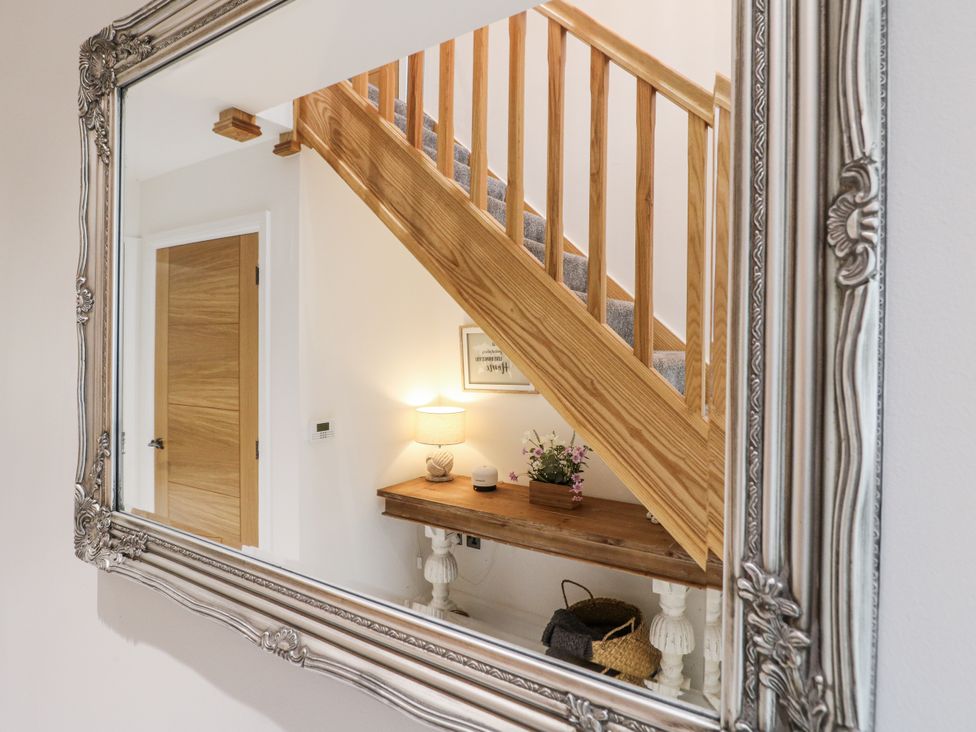A hallway with a staircase and a table at Rockcliffe Grange in Mansfield