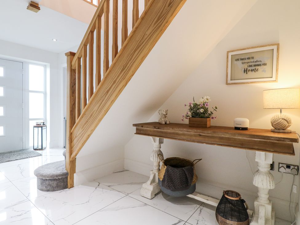 A hallway with a staircase and a table at Rockcliffe Grange in Mansfield