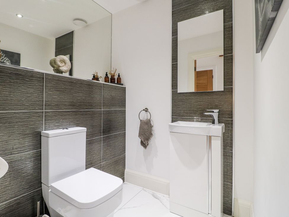 A bathroom with a toilet and sink at Rockcliffe Grange in Mansfield