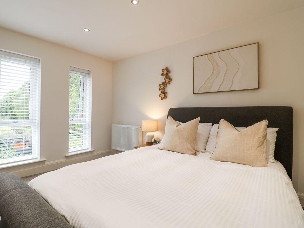 A bedroom with a bed and lamps at Rockcliffe Grange in Mansfield
