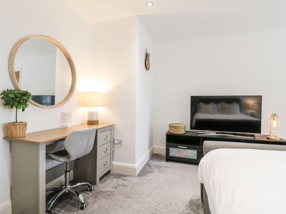 A bedroom with a desk and television at Rockcliffe Grange in Mansfield