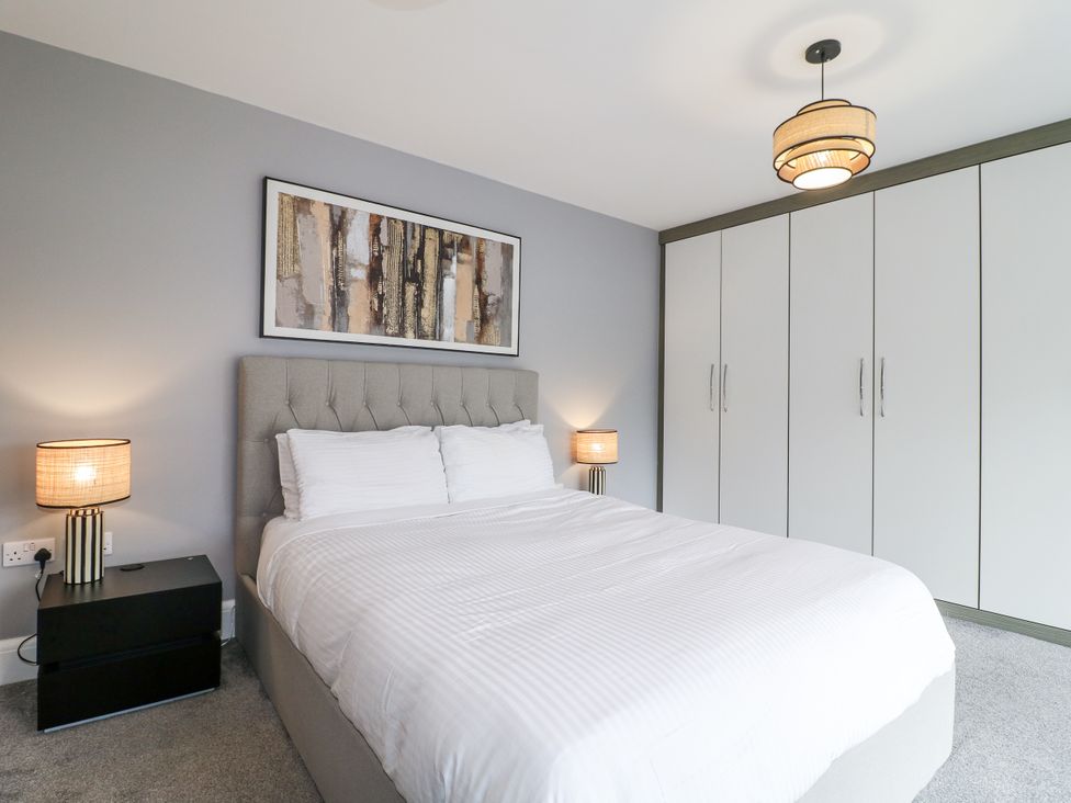 A bedroom with a bed and wardrobe at Rockcliffe Grange in Mansfield