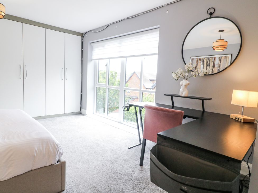 A bedroom with a bed and desk at Rockcliffe Grange in Mansfield